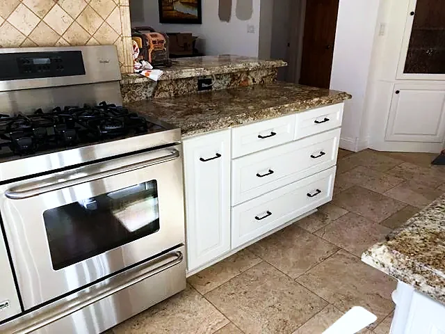 White refinished cabinets with granite counter