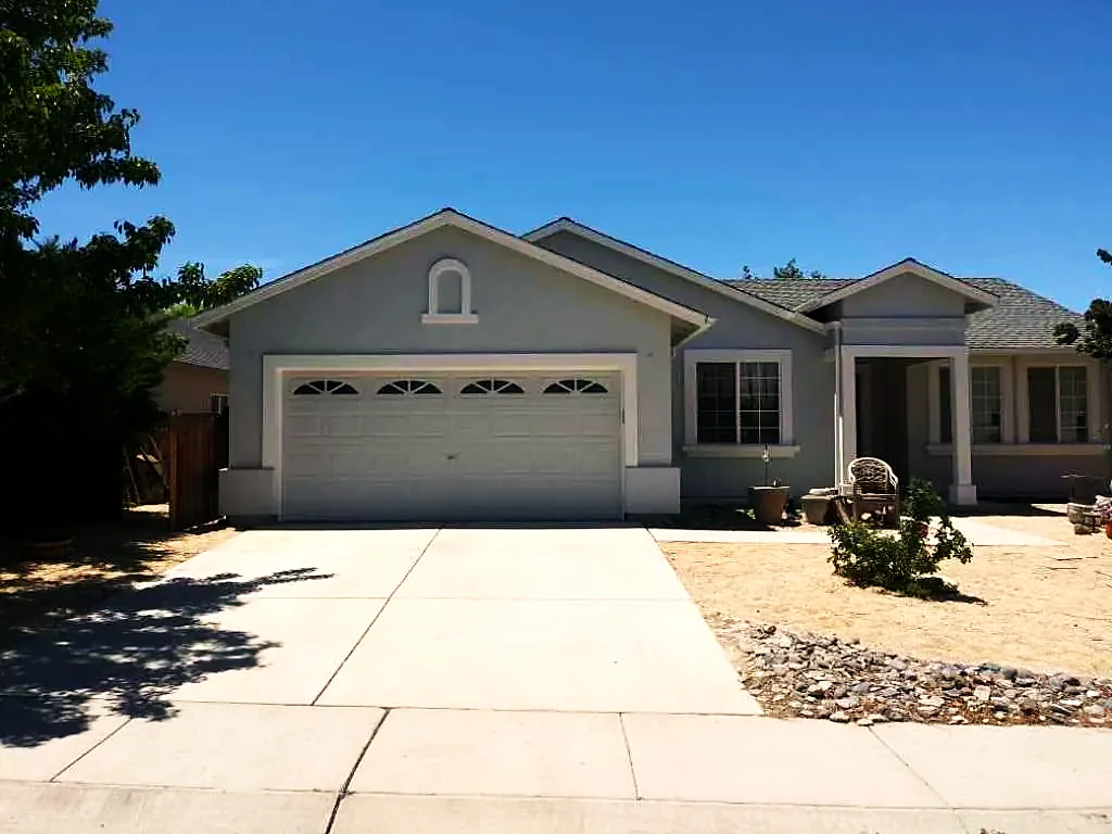 Grey stucco home with painted garage door