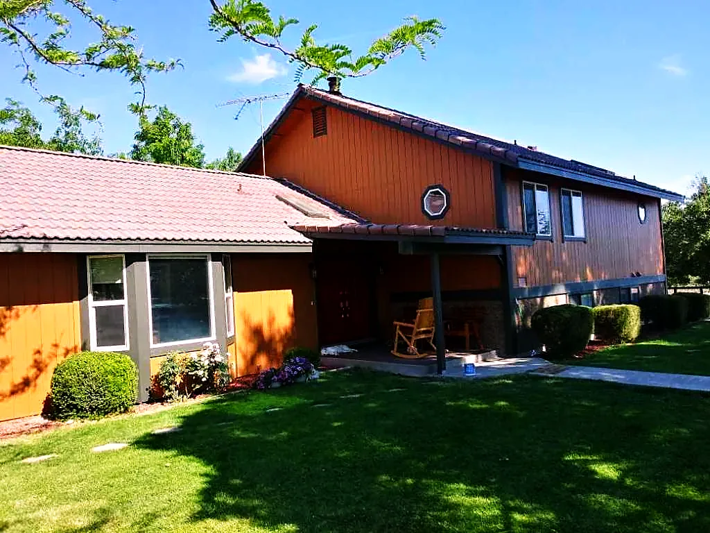 Ranch home repainted in terracotta with red door