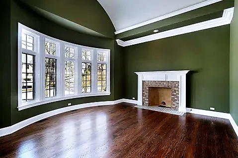 Sage green living room with white fireplace